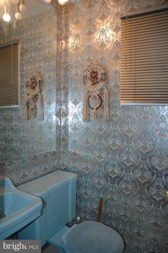4170 Crest Heights Road Baltimore, MD 21215 - Photo 7 of 30 a bathroom with a toilet and a shower