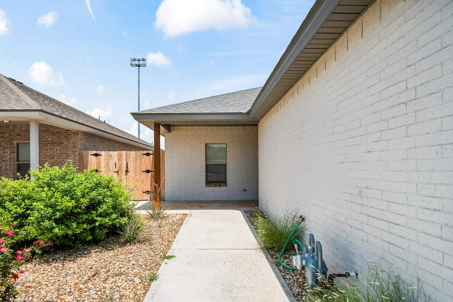 7010 40th Street, Unit A Lubbock, TX 79407 - Photo 3 of 21 a front view of a house with a garden
