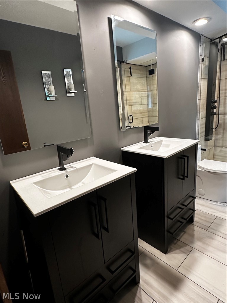 198 Park Road Painesville, OH 44077 - Photo 21 of 31 Dual vanity bathroom featuring modern black cabinetry, integrated white sinks, and matte black fixtures