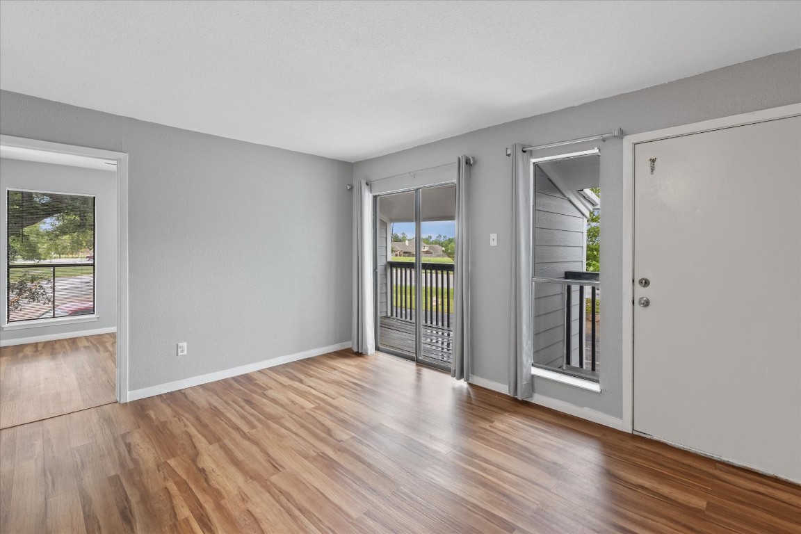 13151 Walden Road, Unit 172 Montgomery, TX 77356 - Photo 12 of 19 wooden floor in an empty room with a window