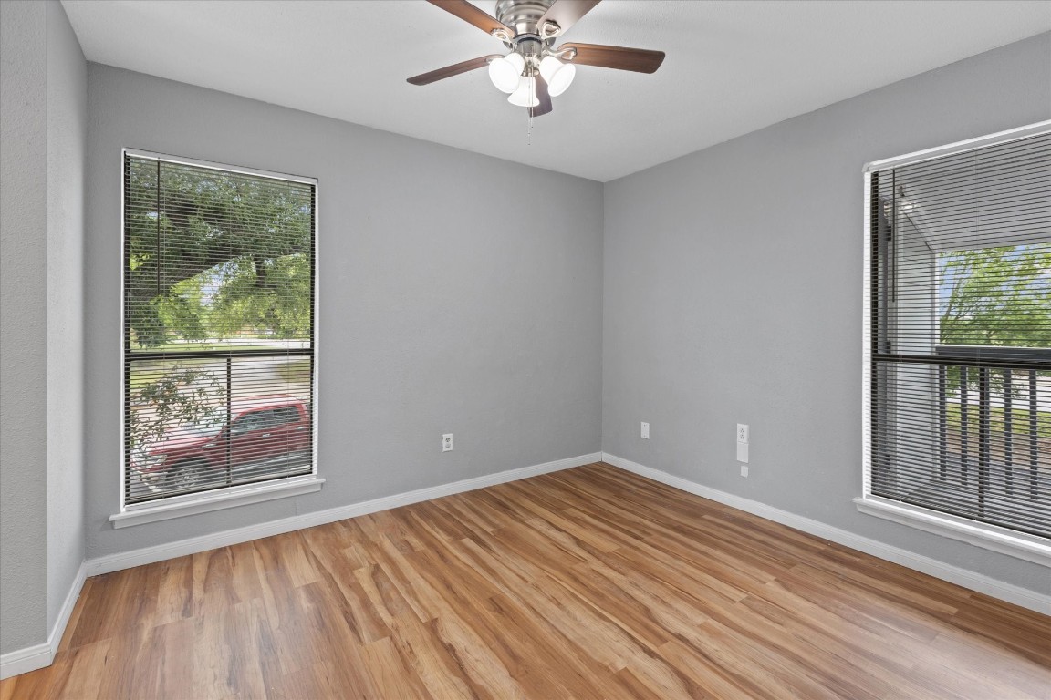 13151 Walden Road, Unit 172 Montgomery, TX 77356 - Photo 13 of 19 a view of an empty room with wooden floor and a window