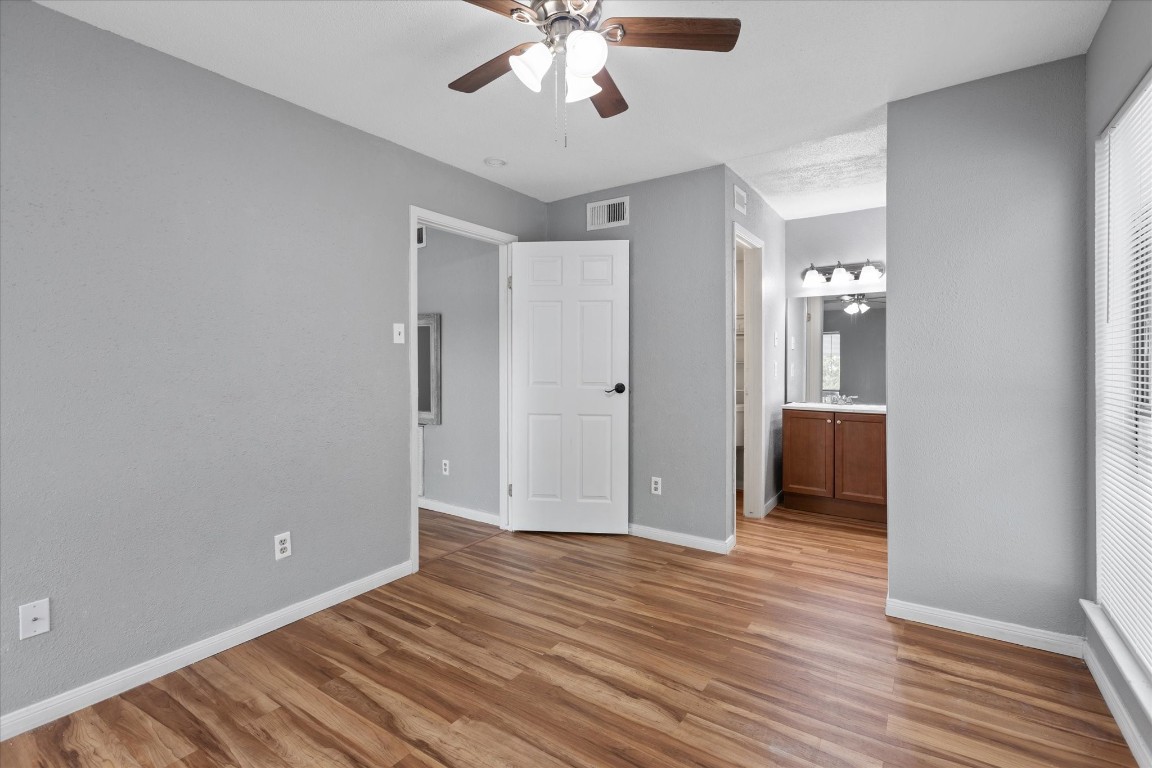 13151 Walden Road, Unit 172 Montgomery, TX 77356 - Photo 14 of 19 a view of a livingroom with a chandelier fan and wooden floor