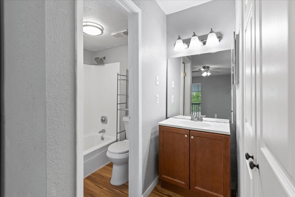13151 Walden Road, Unit 172 Montgomery, TX 77356 - Photo 15 of 19 a bathroom with a granite countertop sink a toilet and shower