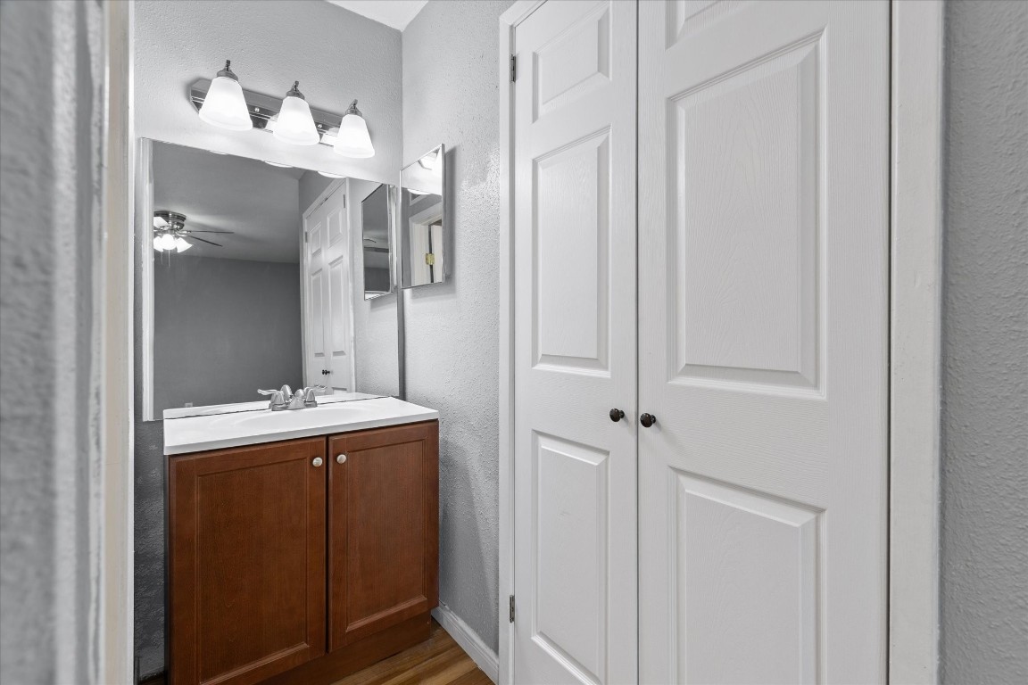 13151 Walden Road, Unit 172 Montgomery, TX 77356 - Photo 16 of 19 a bathroom with a light fixture a mirror and a sink