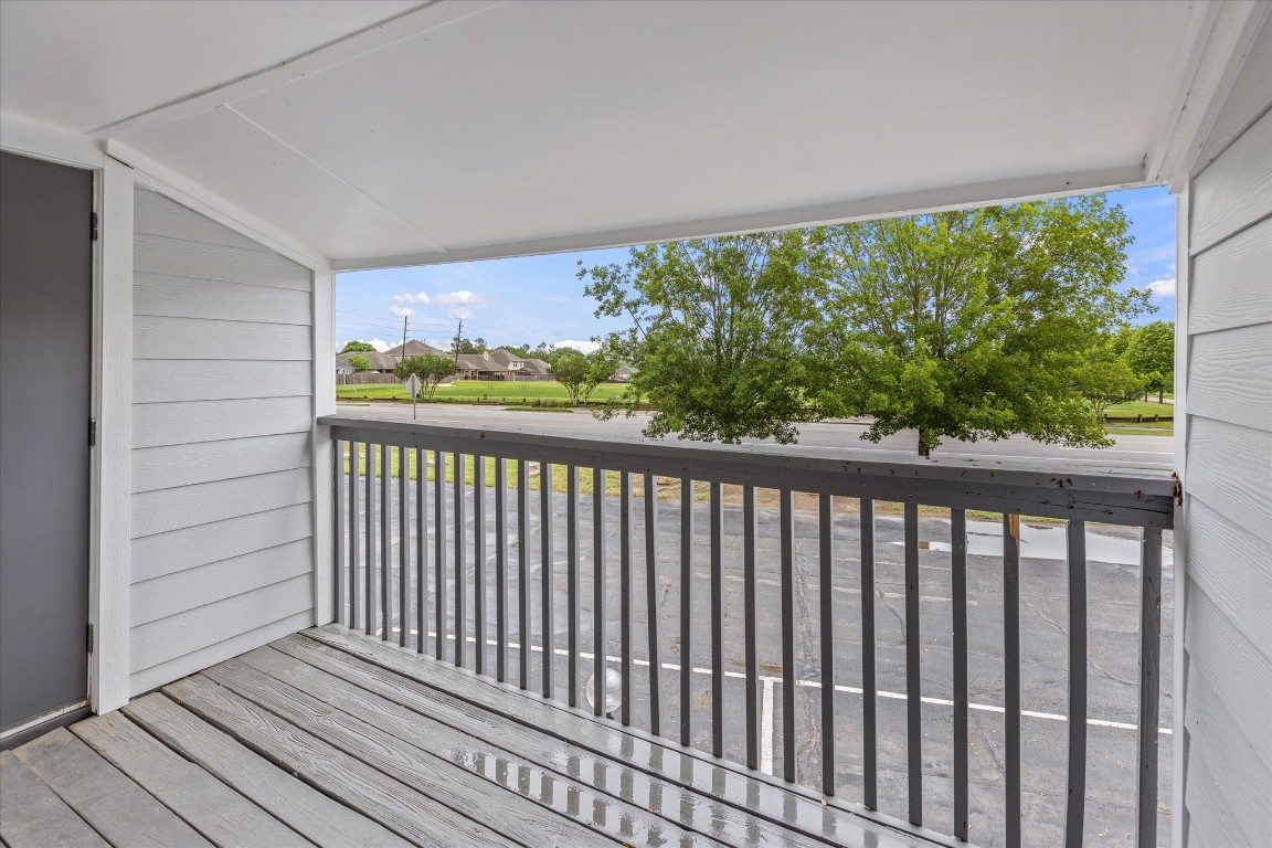 13151 Walden Road, Unit 172 Montgomery, TX 77356 - Photo 18 of 19 a view of a balcony with wooden floor