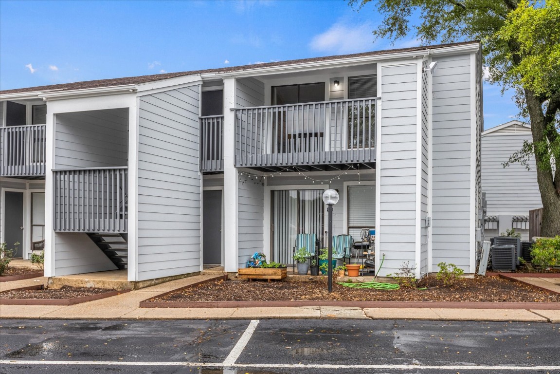 13151 Walden Road, Unit 172 Montgomery, TX 77356 - Photo 2 of 19 a front view of a house with garage and plants