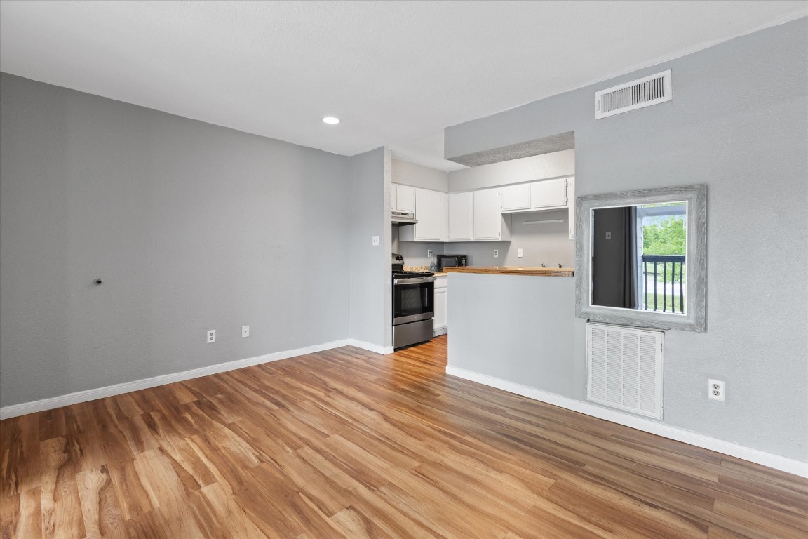 13151 Walden Road, Unit 172 Montgomery, TX 77356 - Photo 5 of 19 a view of a kitchen with wooden floor and a window