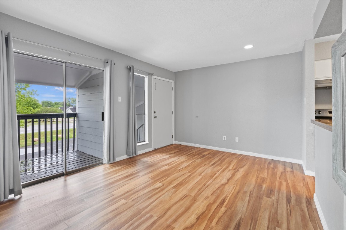 13151 Walden Road, Unit 172 Montgomery, TX 77356 - Photo 6 of 19 a view of empty room with wooden floor and fan