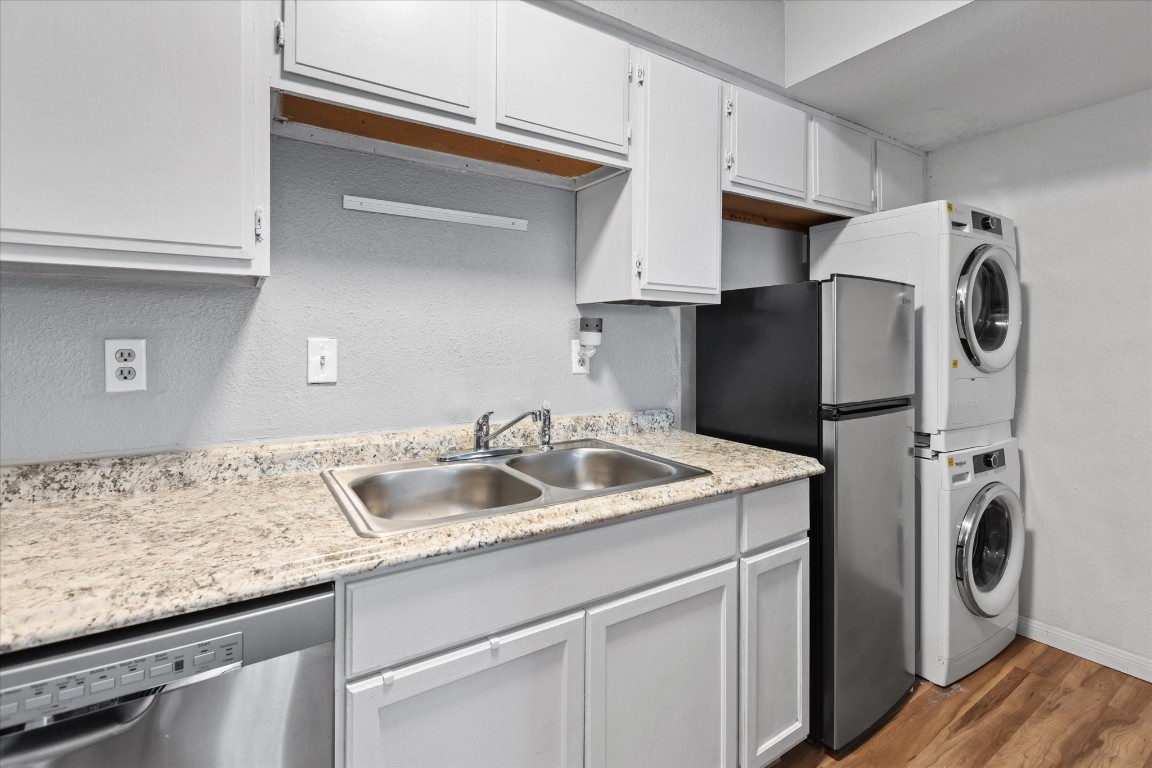 13151 Walden Road, Unit 172 Montgomery, TX 77356 - Photo 9 of 19 a kitchen with stainless steel appliances granite countertop a sink and a refrigerator