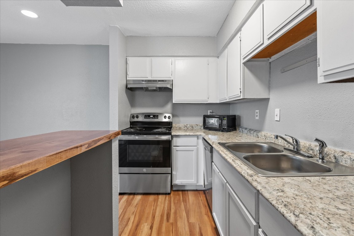 13151 Walden Road, Unit 172 Montgomery, TX 77356 - Photo 10 of 19 a kitchen with a sink stove and cabinets