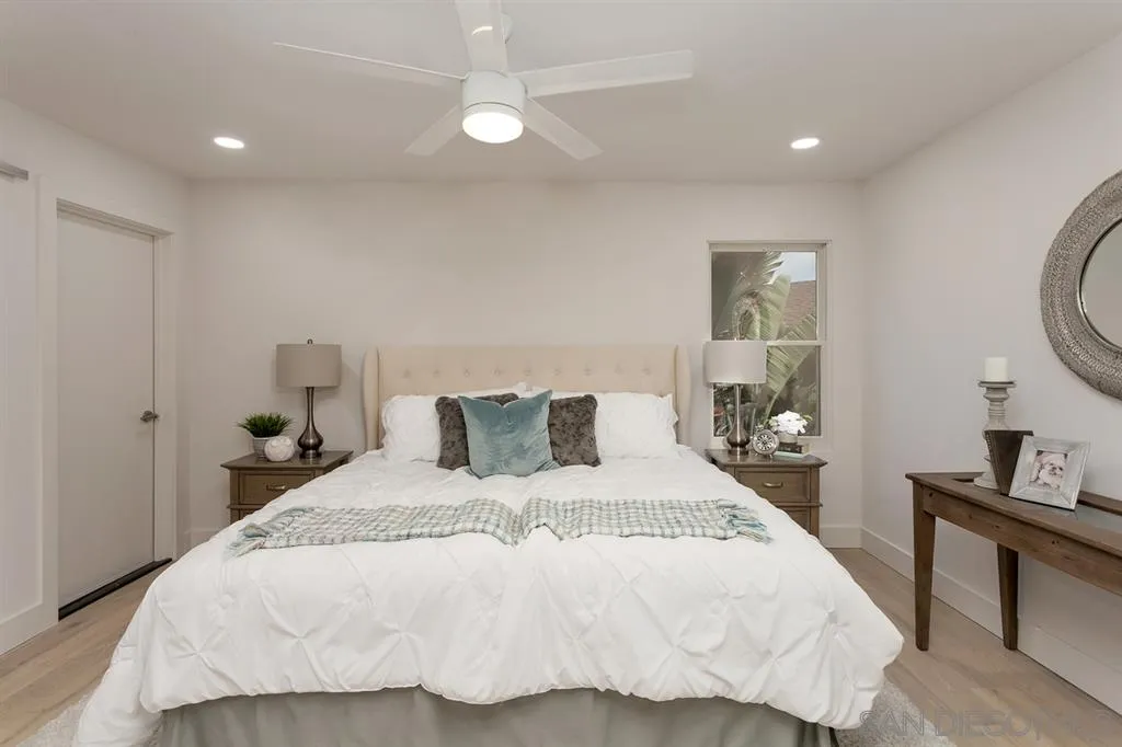 940 Sealane Drive, Unit 6 Encinitas, CA 92024 - Photo 20 of 24 a bedroom with a bed and a lamp on dresser