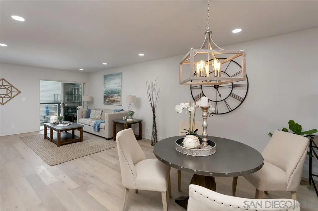 940 Sealane Drive, Unit 6 Encinitas, CA 92024 - Photo 4 of 24 a living room with furniture a mirror and a chandelier
