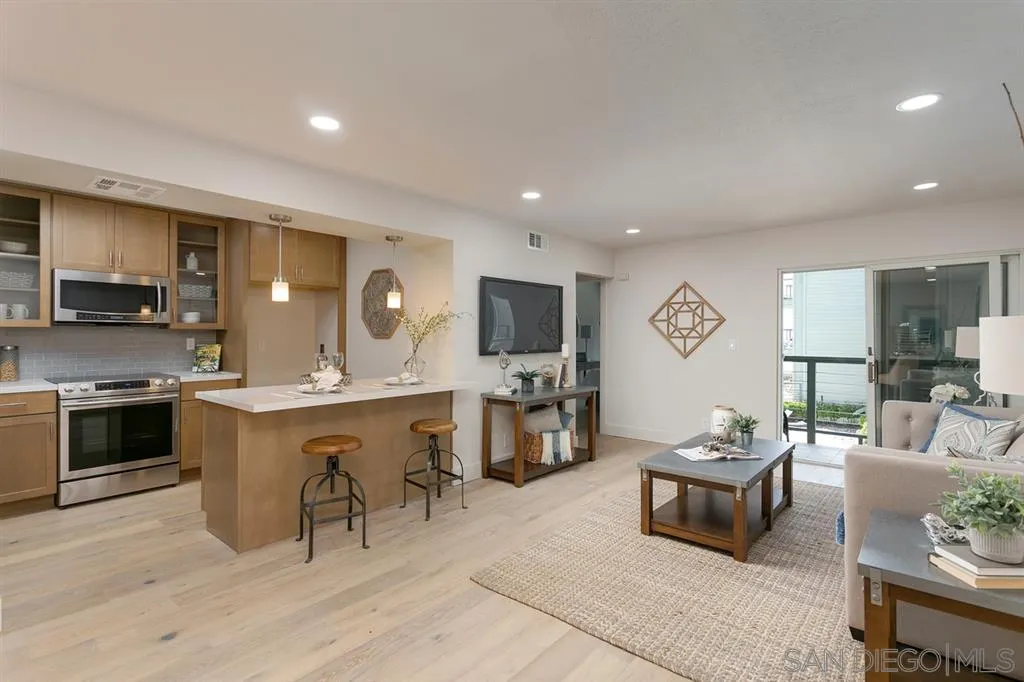 940 Sealane Drive, Unit 6 Encinitas, CA 92024 - Photo 7 of 24 a large kitchen with a table and chairs in it