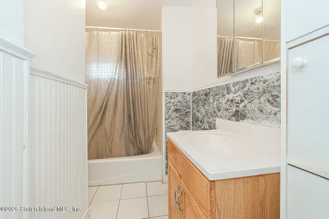 a bathroom with a bathtub and shower