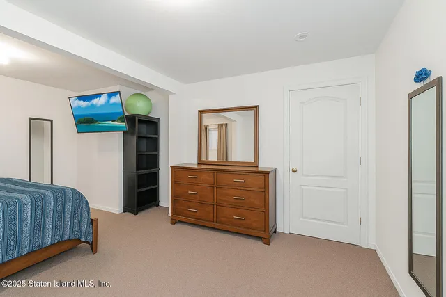 a bedroom with a bed and a dresser