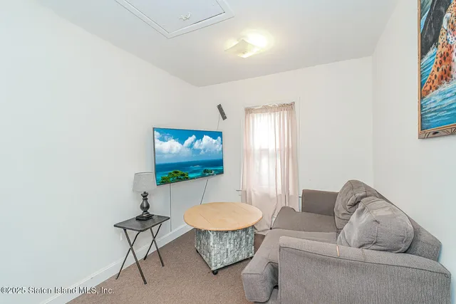 a living room with furniture a rug and a window