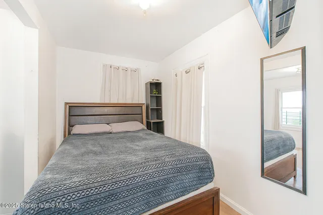 a bedroom with a bed and balcony view
