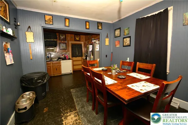 a dining room with a table and chairs