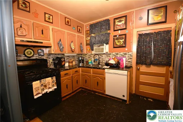a kitchen with stainless steel appliances granite countertop a stove and a refrigerator