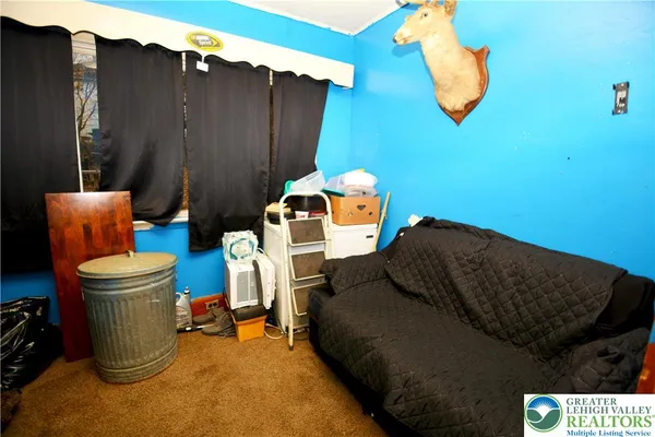 a bedroom with a bed and a mirror