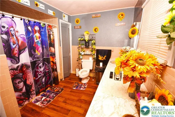a bedroom with a bed and a painting on the wall
