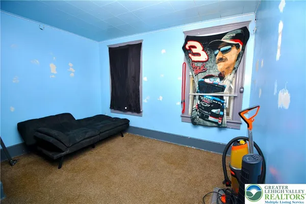 a living room with furniture and a gym equipment