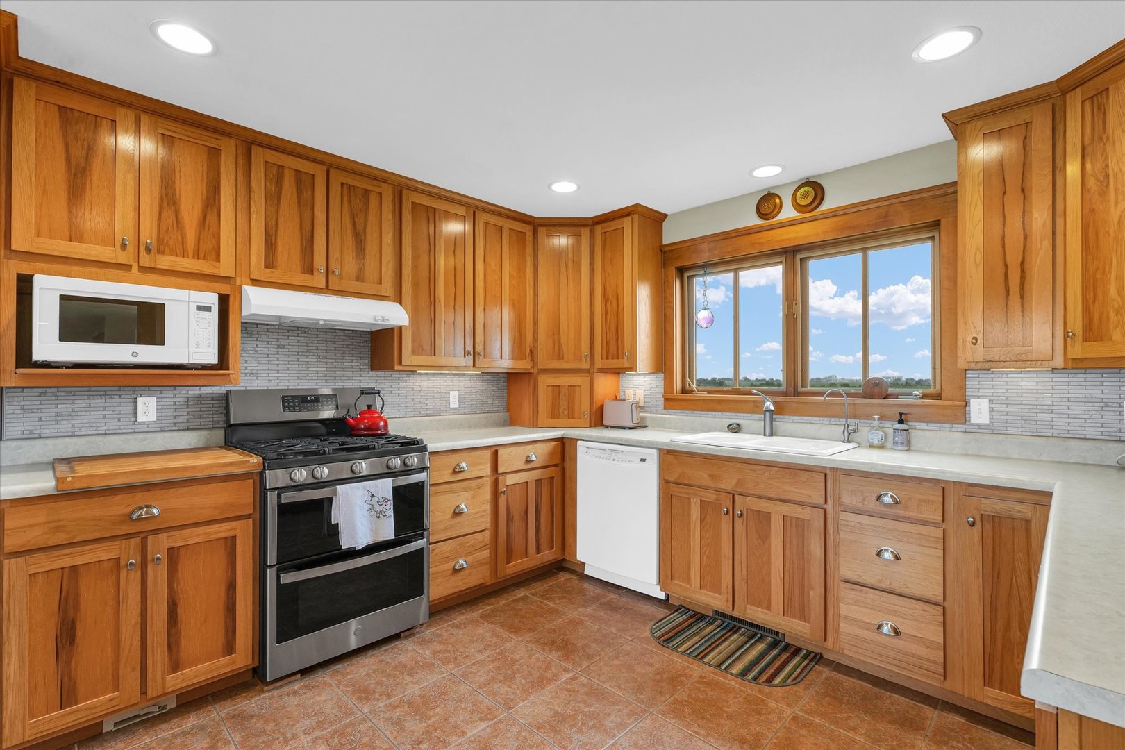 647 County Farm Road Monticello, IL 61856 - Photo 19 of 74 a kitchen with granite countertop a sink stainless steel appliances and cabinets