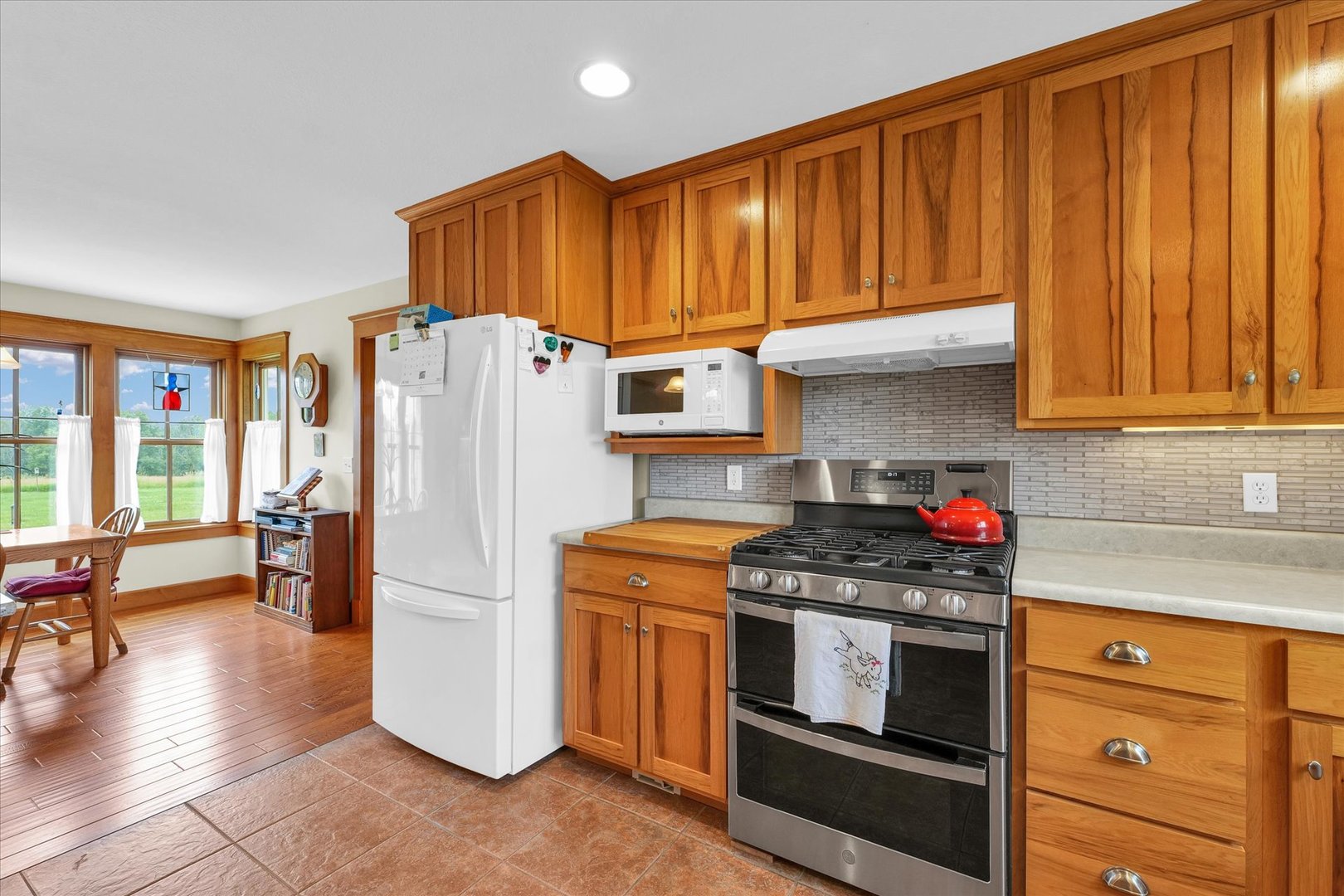 647 County Farm Road Monticello, IL 61856 - Photo 20 of 74 a kitchen with granite countertop wooden cabinets and stainless steel appliances