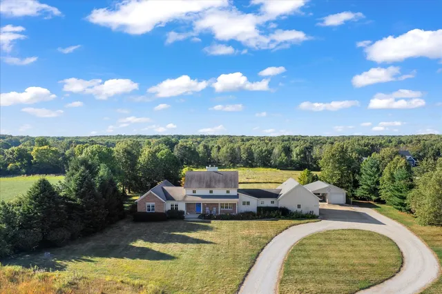 a view of swimming pool with seating area and lake in the background