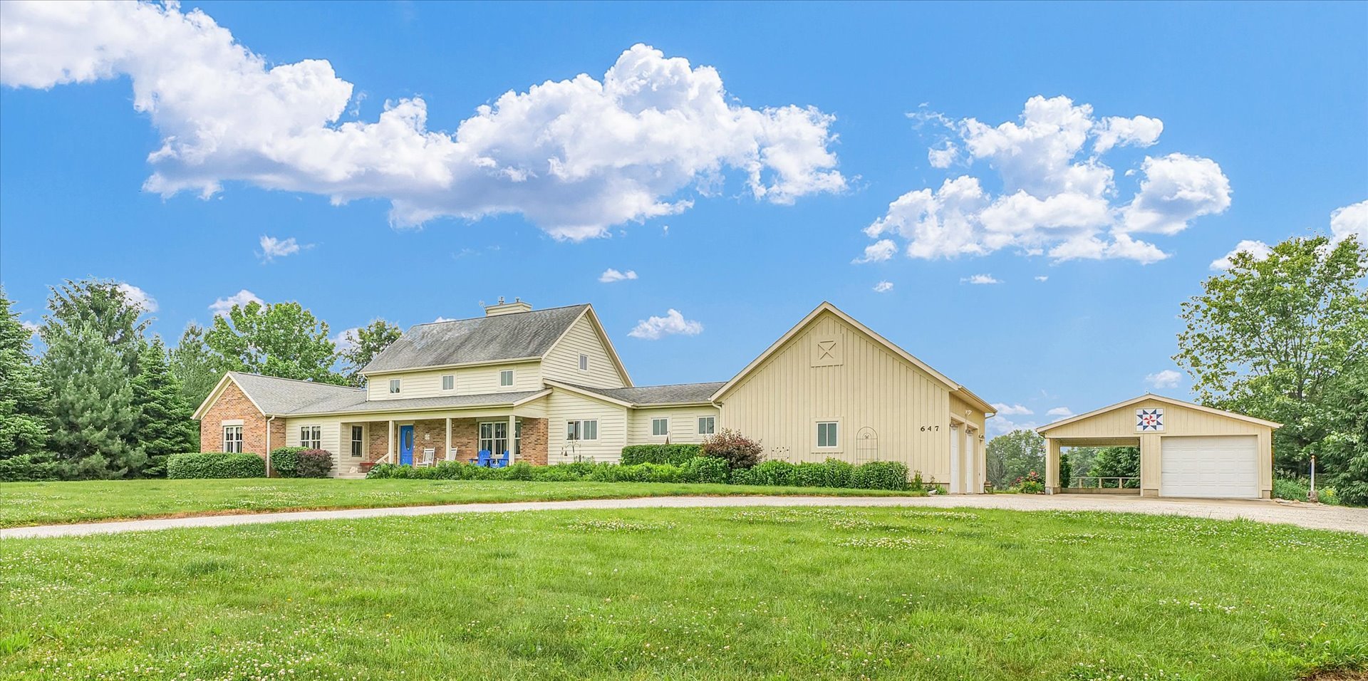 647 County Farm Road Monticello, IL 61856 - Photo 4 of 74 a front view of a house with garden