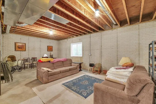 a view of a swimming pool with a patio and a yard