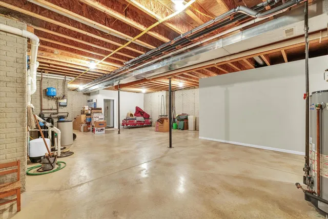 a view of a house with a big yard and large trees