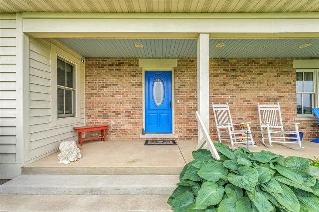 a front view of a house with a potted plant