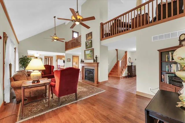 a living room with furniture a fireplace and a chandelier