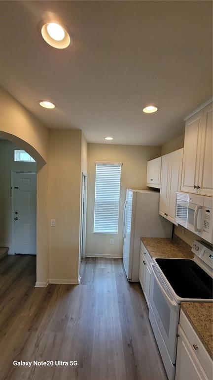 8814 Walnut Gable Court Riverview, FL 33578 - Photo 2 of 10 a kitchen with a sink a refrigerator and cabinets