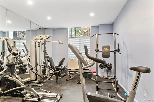 a picture of a wall with a white cabinet and a microwave