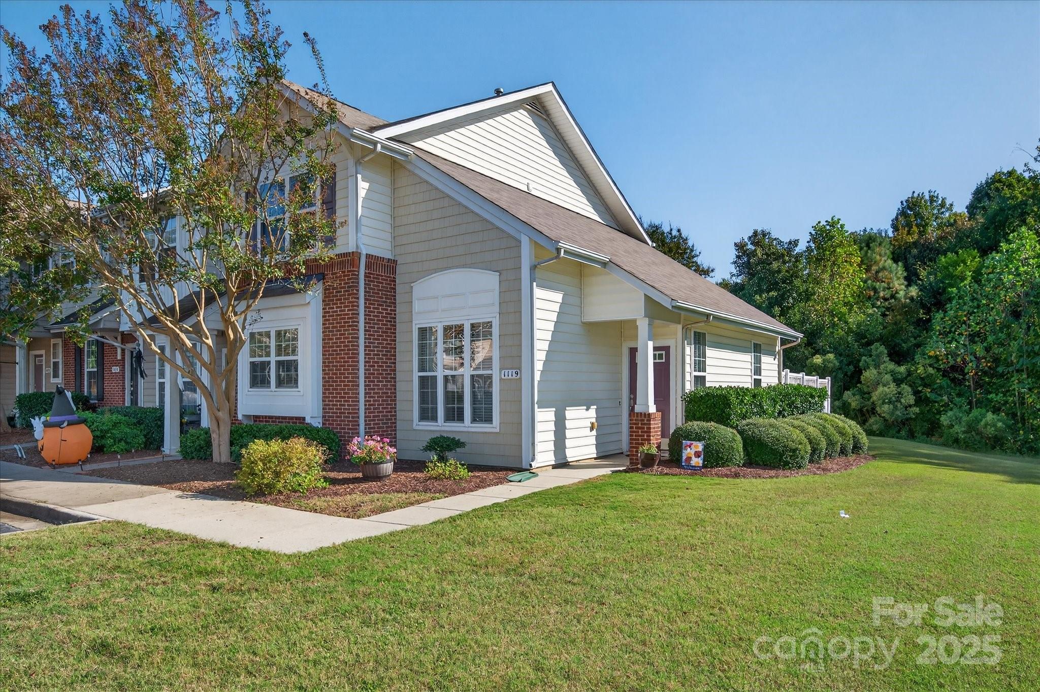 1119 Sienna Sand Way Fort Mill, SC 29708 - Photo 1 of 36 a front view of a house with a yard and potted plants