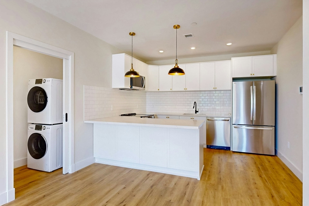 476 Warren Street Boston, MA 02121 - Photo 11 of 29 a kitchen with refrigerator and wooden floor