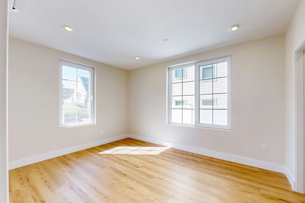 476 Warren Street Boston, MA 02121 - Photo 15 of 29 a view of empty room with wooden floor and fan