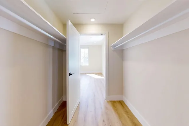 a view of a hallway with wooden floor