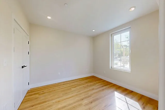 a view of a room that has a bed and a window