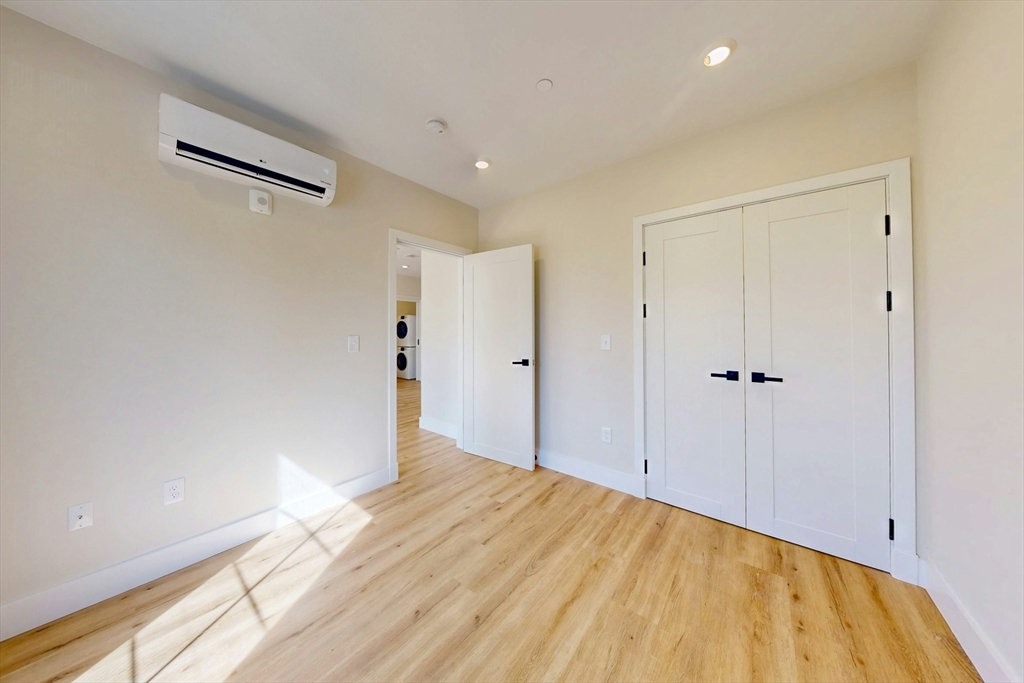 476 Warren Street Boston, MA 02121 - Photo 22 of 29 a view of a big room with closet and wooden floor