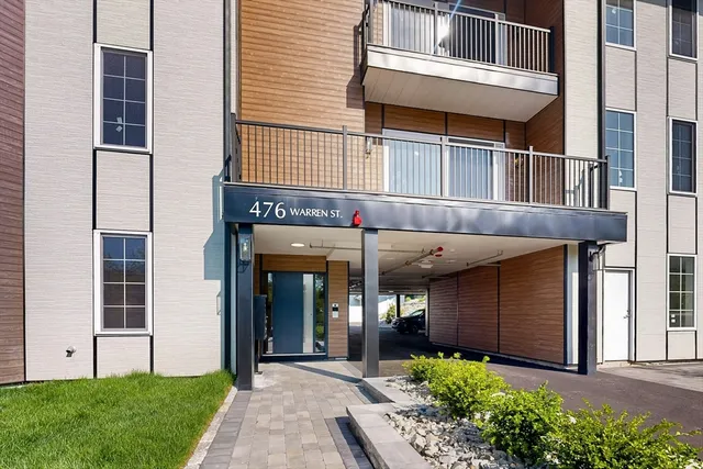 a view of a house with potted plants and a yard