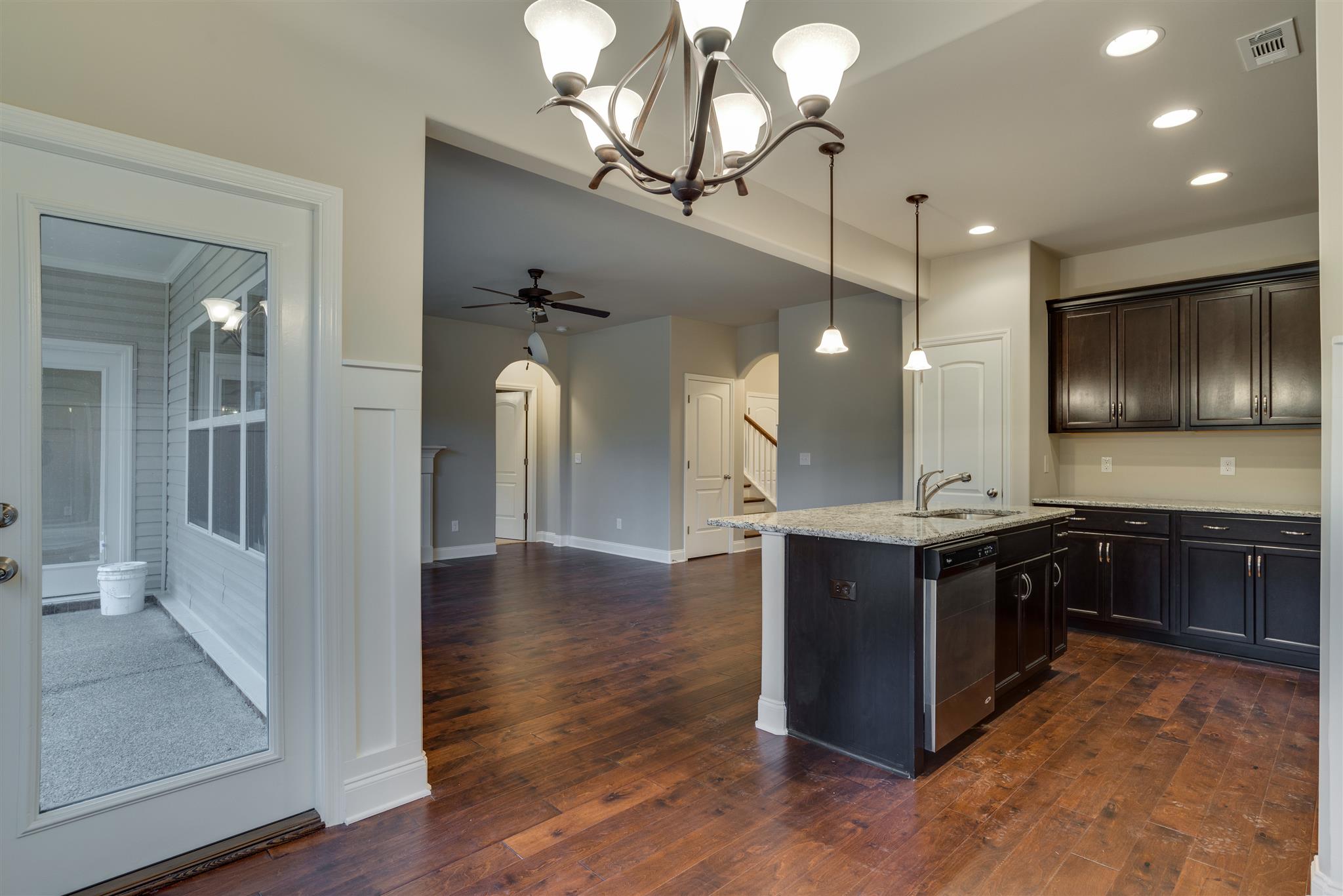 3006 Wesley Road, Unit 219MCGRAW Spring Hill, TN 37174 - Photo 25 of 25 Open floor plan. View from dining room to kitchen, family room and covered porch