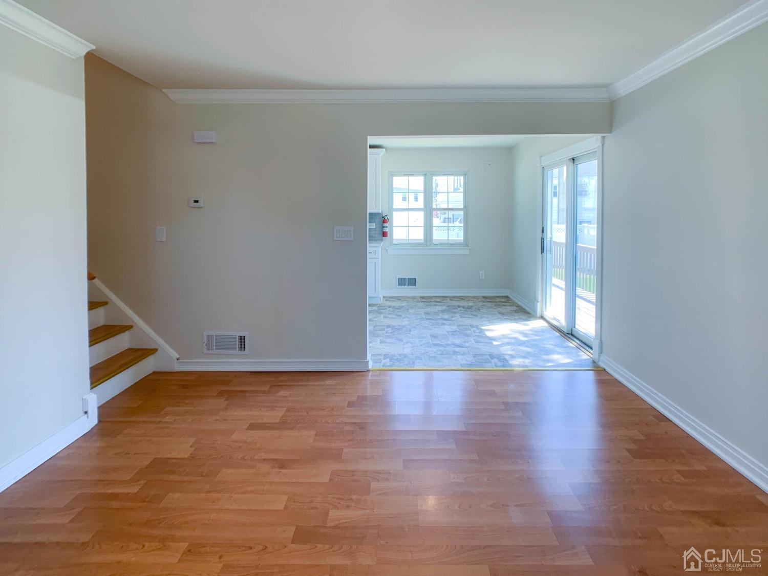 2 Darrell Court Edison, NJ 08817 - Photo 5 of 25 an empty room with wooden floor and windows