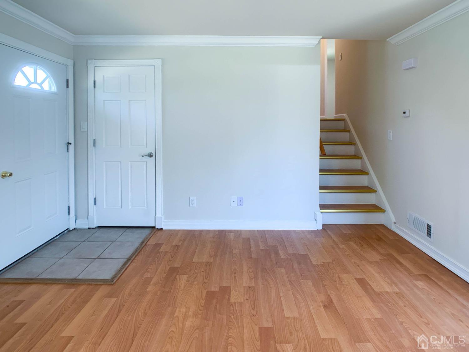 2 Darrell Court Edison, NJ 08817 - Photo 9 of 25 a view of a room with wooden floor and white walls