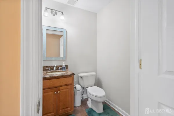 a white toilet sitting next to a bathroom sink