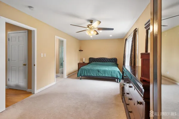 a view of a hallway to a hallway with a bedroom