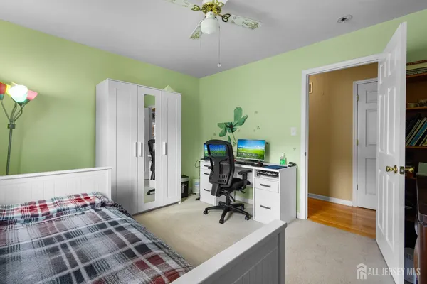 a view of a workspace with furniture and a chandelier