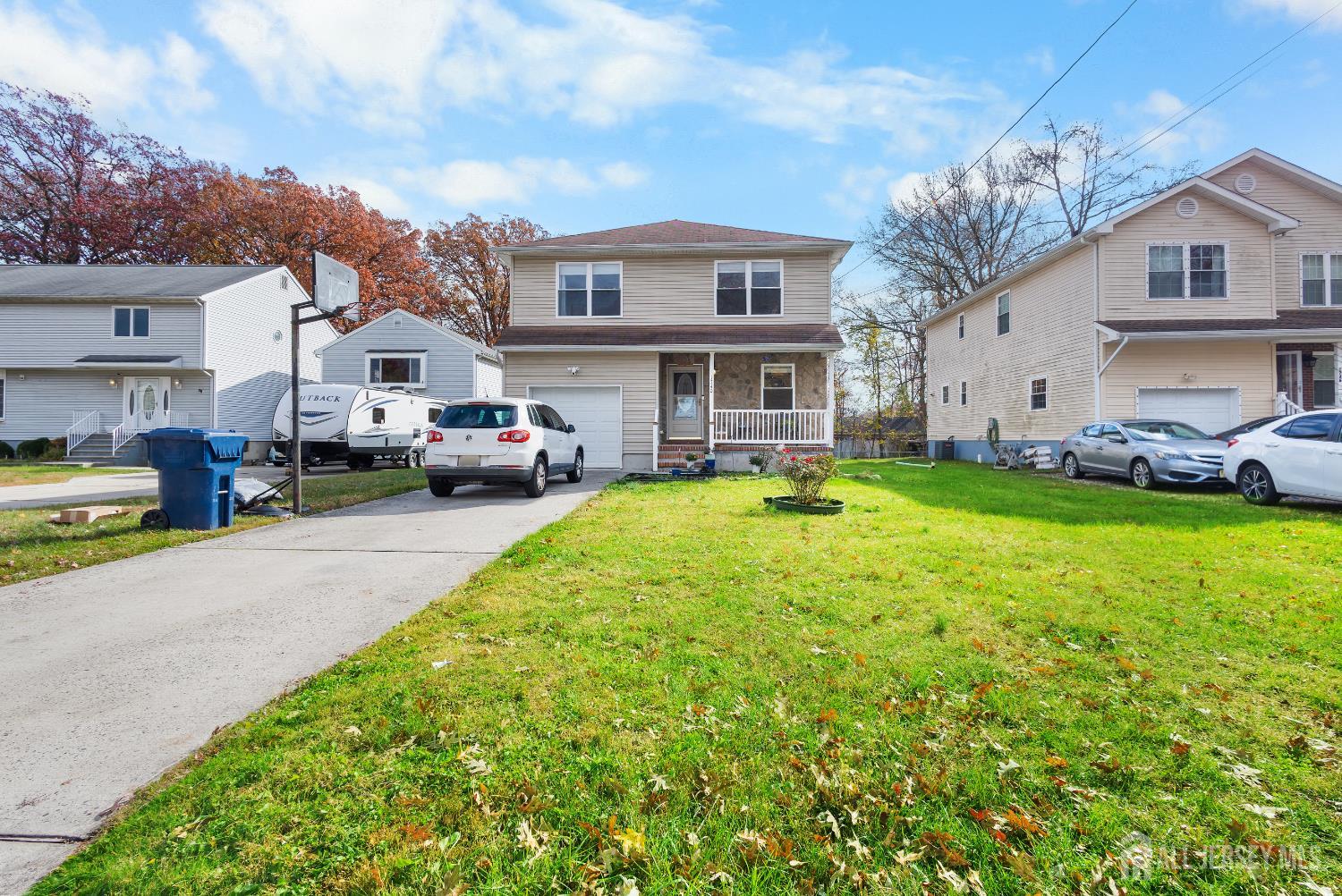 1740 Holly Road North Brunswick, NJ 08902 - Photo 2 of 32 a front view of a house with a garden and trees